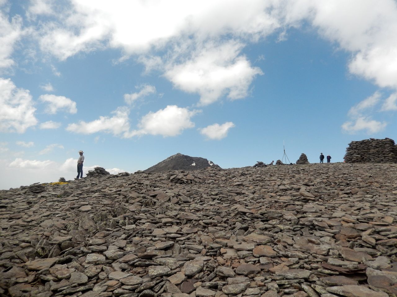 Hikers among the cairns high on Mount Aragats